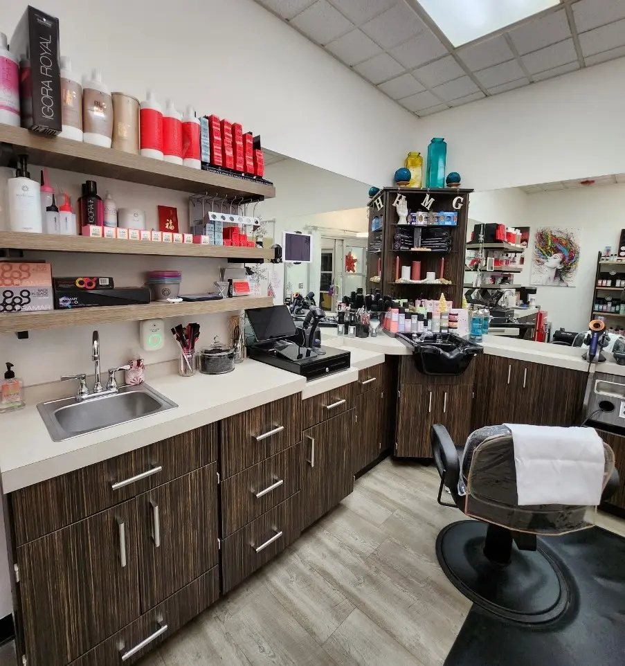 A barber shop with many different hair products on the shelves.