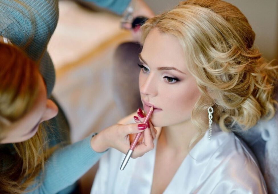A woman getting her makeup done by a professional.
